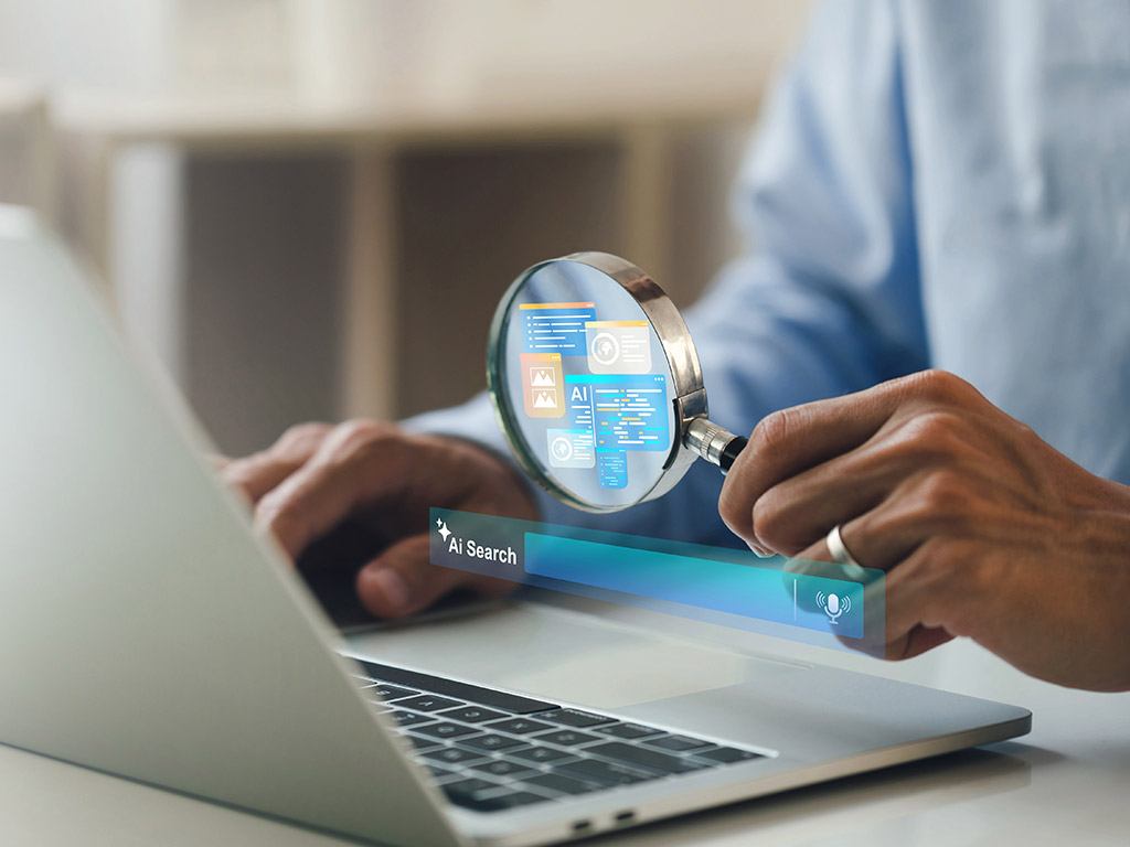 AI searching concept. artificial intelligence tool, Businessman holding a magnifying glass an AI icon and a Search engine bar on laptop